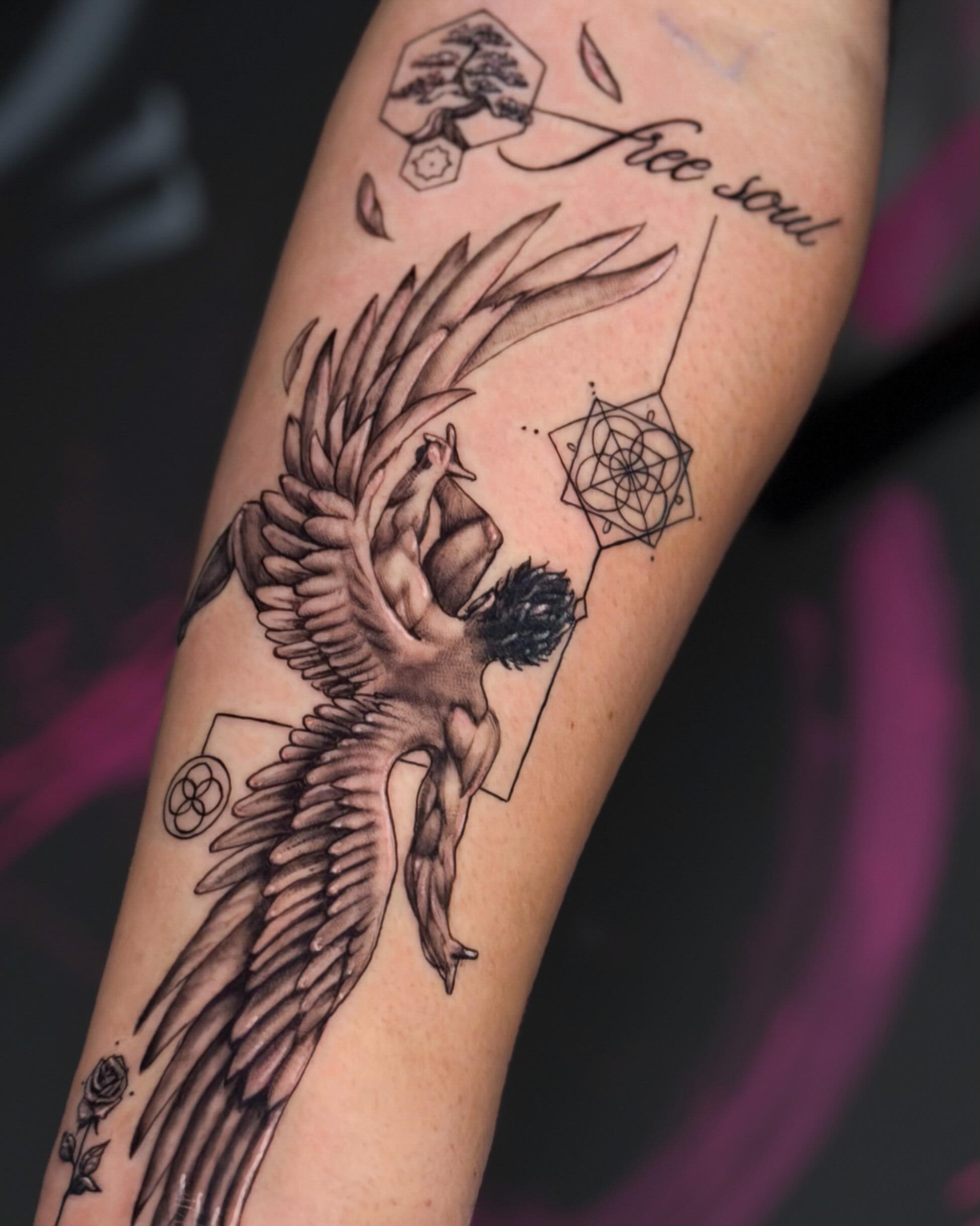 Fine-line winged figure, Free Soul tattoo
